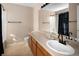 Neutral bathroom with a single sink vanity, large mirror, and shower/tub combo with black curtain at 9150 Gale Blvd # 1, Thornton, CO 80260