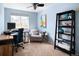 Cozy bedroom features a work space, light blue walls, and a sitting area near a window at 9150 Gale Blvd # 1, Thornton, CO 80260