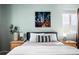 Bright bedroom featuring a bed with decorative pillows and paintings at 9150 Gale Blvd # 1, Thornton, CO 80260