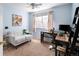 Bright bedroom with a loveseat, desk, and ladder shelf with plenty of natural light at 9150 Gale Blvd # 1, Thornton, CO 80260