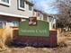 Autumn Creek community sign with brick base and beige townhome buildings in the background on a sunny day at 9150 Gale Blvd # 1, Thornton, CO 80260