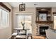 Cozy dining area with modern lighting and a view of the fireplace and backyard at 9150 Gale Blvd # 1, Thornton, CO 80260