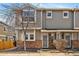 Charming townhome featuring a well-maintained front yard and a cozy entrance with decorative stone accents at 9150 Gale Blvd # 1, Thornton, CO 80260