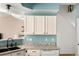 Well-lit kitchen featuring a black sink, granite countertops, white cabinetry, and hardwood floors at 9150 Gale Blvd # 1, Thornton, CO 80260