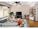 Spacious living room featuring hardwood floors, large windows, floating shelves, and modern decor at 9150 Gale Blvd # 1, Thornton, CO 80260