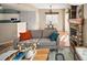Open-concept living space with hardwood floors, a fireplace, and seamless transition to the kitchen area at 9150 Gale Blvd # 1, Thornton, CO 80260