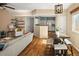 Open concept living space with modern decor, hardwood floors, and seamless flow to the kitchen and dining area at 9150 Gale Blvd # 1, Thornton, CO 80260