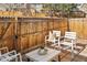 Cozy outdoor patio with a wood fence, string lights, and ample seating at 9150 Gale Blvd # 1, Thornton, CO 80260
