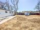 Large backyard with white siding home and storage shed at 5539 Atchison St, Denver, CO 80239