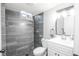 Updated bathroom with tiled walls and floors features a modern vanity at 5539 Atchison St, Denver, CO 80239