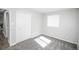 This bedroom features neutral-colored walls and carpet with a window and closet for storage at 5539 Atchison St, Denver, CO 80239