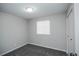 This bedroom features neutral-colored walls and carpet with a window for natural light at 5539 Atchison St, Denver, CO 80239