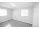 This bedroom features neutral-colored walls and carpet with a window for natural light at 5539 Atchison St, Denver, CO 80239