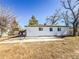 Exterior of home with white siding and large concrete pad at 5539 Atchison St, Denver, CO 80239