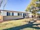 Charming exterior of home with blue shutters, well-maintained lawn, and mature trees at 5539 Atchison St, Denver, CO 80239