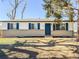 Charming single-story home featuring a brick facade, blue shutters and a matching front door at 5539 Atchison St, Denver, CO 80239