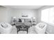 Cozy living room with a neutral color scheme, comfortable seating, and natural light from a window at 5539 Atchison St, Denver, CO 80239