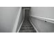 A neutral-colored stairway featuring carpet steps and white railings at 5539 Atchison St, Denver, CO 80239