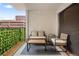 Cozy balcony with outdoor seating, artificial greenery, and a view of the surrounding buildings at 2 Adams Street # 108, Denver, CO 80206