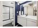 Bathroom with a black-framed shower and tub combination and white vanity at 2 Adams Street # 108, Denver, CO 80206