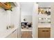 Bright hallway with white tiled walls and stylish kitchen view at 2 Adams Street # 108, Denver, CO 80206