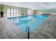 Inviting indoor pool with tile surround, tranquil lighting and easy access to the outdoors at 2 Adams Street # 108, Denver, CO 80206