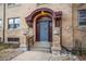 Charming brick building features arched doorway, concrete steps and two decorative stone urns at 2101 S Josephine St # 202, Denver, CO 80210