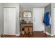 Functional entryway with wood floors, decorative mirror, storage, and coat rack near the front door at 2101 S Josephine St # 202, Denver, CO 80210