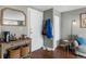 Bright entryway featuring wood floors, a mirror, and a table with storage baskets and decorative items at 2101 S Josephine St # 202, Denver, CO 80210