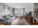 Bright living room with a comfortable gray sofa, stylish rug, and lots of natural light from the window at 2101 S Josephine St # 202, Denver, CO 80210