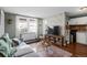 Inviting living room featuring a gray sofa, wood floors, and a large window with natural light at 2101 S Josephine St # 202, Denver, CO 80210