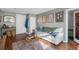 Comfortable living room featuring a gray sofa, wood floors, and adjacent doorway to another room at 2101 S Josephine St # 202, Denver, CO 80210