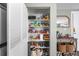 Pantry features built-in shelving to keep items organized in this kitchen area at 2101 S Josephine St # 202, Denver, CO 80210