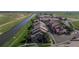An aerial shot showing the layout of a townhome community with nearby green spaces and water features at 10449 Paris St # 207, Commerce City, CO 80640