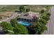 Aerial photo showing the community pool, clubhouse, and amenities with surrounding mature trees and landscaping at 10449 Paris St # 207, Commerce City, CO 80640