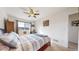 Comfortable bedroom with a full size bed, ceiling fan, and a bright window at 10449 Paris St # 207, Commerce City, CO 80640