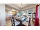 Open-concept dining room with a large island, tile flooring, and a seamless flow to the kitchen and living areas at 10449 Paris St # 207, Commerce City, CO 80640