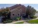 Exterior of a home featuring stone and siding accents, complemented by green lawn and landscaping at 10449 Paris St # 207, Commerce City, CO 80640