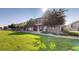 Well-maintained home exterior with a lush green lawn and mature trees at 10449 Paris St # 207, Commerce City, CO 80640