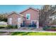 Beautiful house exterior with stone accents, landscaped yard, and a small porch at 10449 Paris St # 207, Commerce City, CO 80640