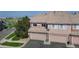 Charming townhome with a private garage, mature landscaping, and a well-maintained exterior at 10449 Paris St # 207, Commerce City, CO 80640