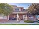 Charming home featuring a cozy front porch with comfortable seating and well-manicured landscaping at 10449 Paris St # 207, Commerce City, CO 80640