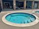 A well maintained community hot tub with tile surround and exterior seating and shade at 10449 Paris St # 207, Commerce City, CO 80640