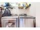 Modern laundry room featuring a front load washer and dryer with wire rack shelving above at 10449 Paris St # 207, Commerce City, CO 80640