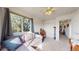Bright living room with a large window, a sectional sofa, and a view of the backyard at 10449 Paris St # 207, Commerce City, CO 80640