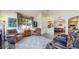 Cozy living room showcasing plush seating, large windows, and an open layout leading into the dining area at 10449 Paris St # 207, Commerce City, CO 80640