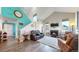 Inviting living room with soaring ceilings, a cozy fireplace, and ample natural light from the windows at 10449 Paris St # 207, Commerce City, CO 80640