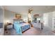 Bright main bedroom with neutral walls, and ensuite bathroom, creating a serene retreat at 10449 Paris St # 207, Commerce City, CO 80640