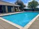 A serene community swimming pool surrounded by a well-maintained deck and lush landscaping at 10449 Paris St # 207, Commerce City, CO 80640
