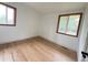 Bright bedroom with hardwood floors and natural light from two windows at 3355 Moorhead Ave, Boulder, CO 80305